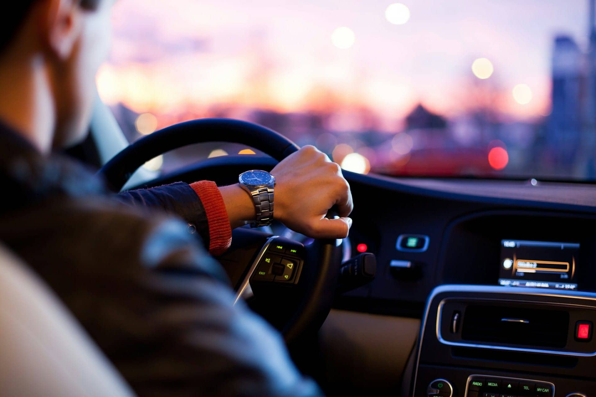 Driver at the wheel at sunset